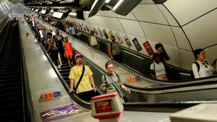Commuters at London Bridge underground station during a heatwave in London, UK