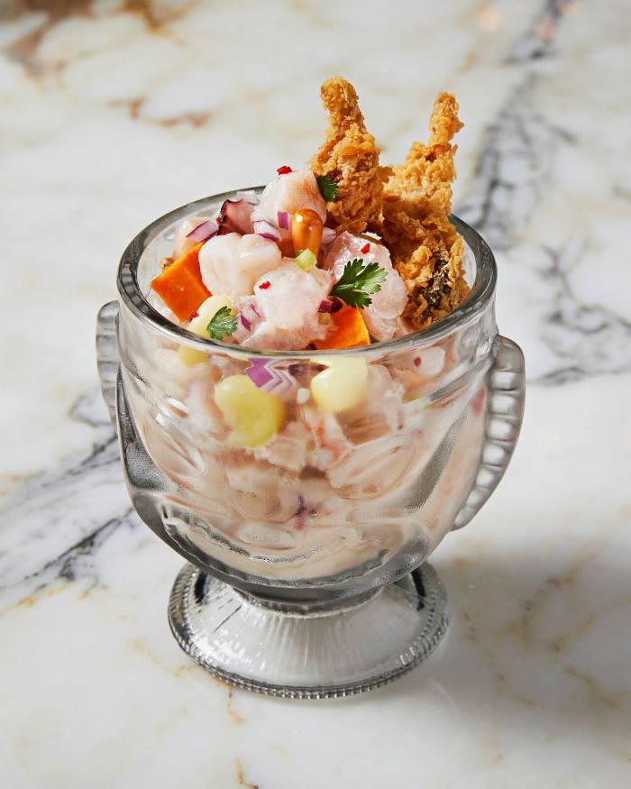 A bowl of La Mar’s ceviche carretillero: grouper, shrimp, octopus and calamari mixed with sweet potato, choclo (Peruvian corn), cancha (corn nuts) and leche de tigre