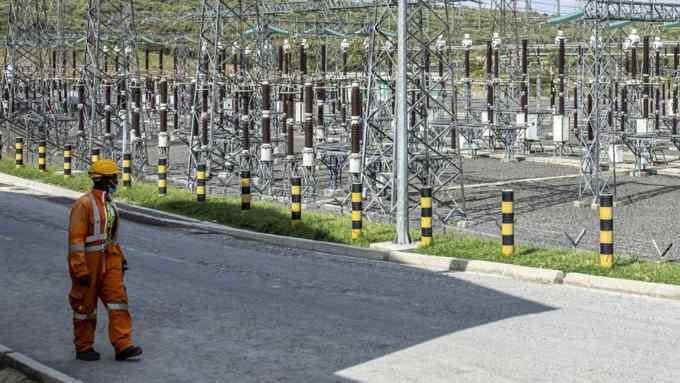 A worker passes an electricity substation