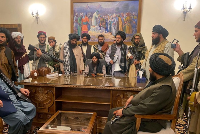 Taliban fighters installing themselves in the presidential palace in Kabul on August 15, after taking control of the city. President Ashraf Ghani fled later that evening 