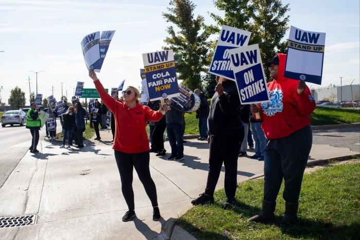 United Auto Workers members and supporters form a picket line