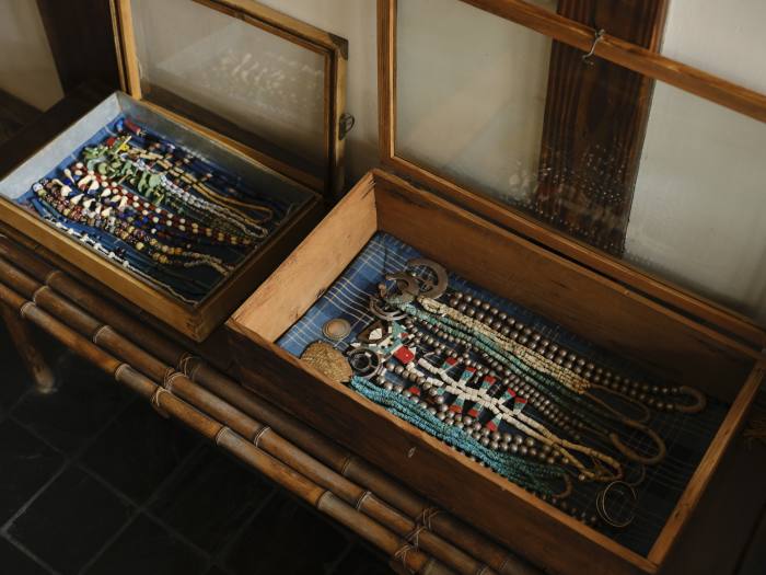 Two glass-topped boxes hold her collection of pearl necklaces