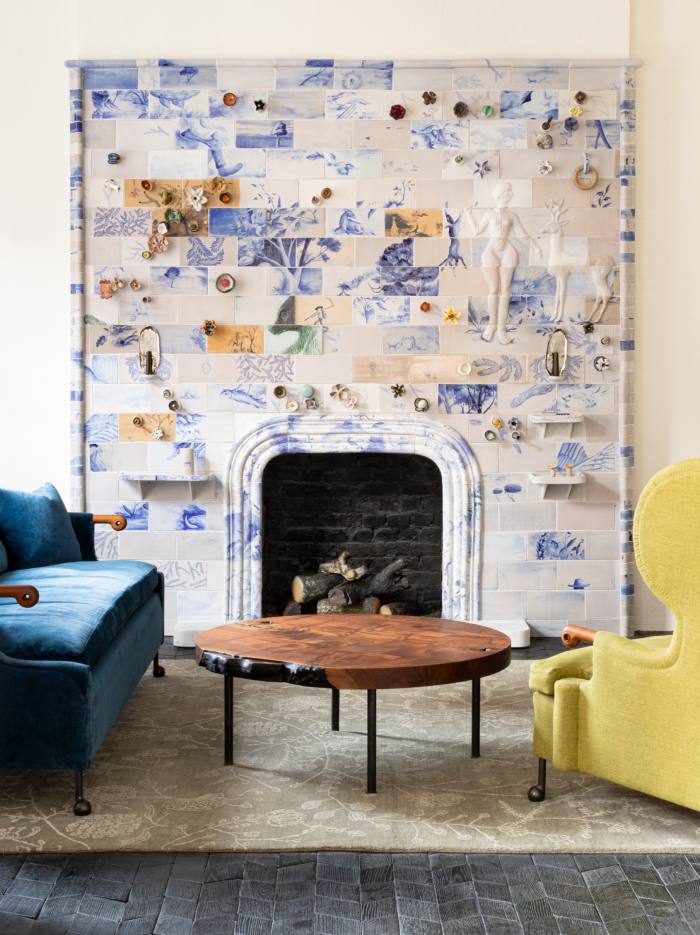 The BDDW gallery in Mayfair, featuring a ceramic fireplace built with hand-painted tiles from Tyler’s BDDW Ceramic studio. Also pictured are an Abel sofa, Wingback chair, Claro Walnut Slab coffee table, and BDDW Handrawn rug