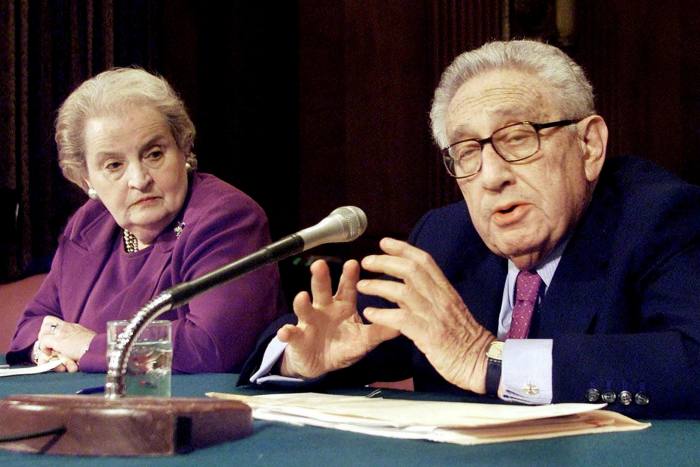 Madeleine Albright testifies alongside Henry Kissinger at a Senate hearing in 2002