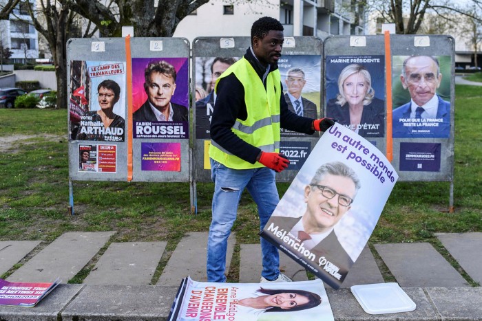A man displays campaign posters in Nantes. France’s far left and far right share an anger against the establishment and a sense of economic exclusion
