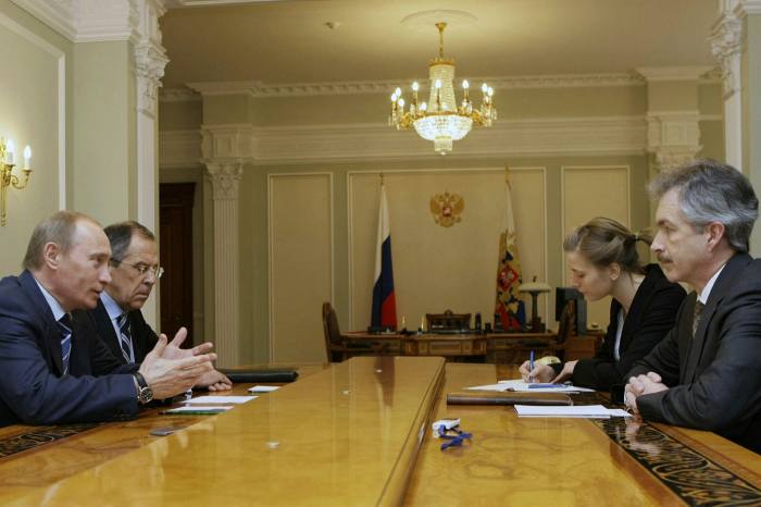 Vladimir Putin sits at a negotiating table across from William Burns (then US ambassador to Moscow) in March 2008