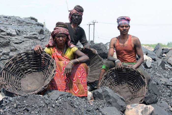 Indian coal loaders take a rest at an open cast mine in Dhanbad, India