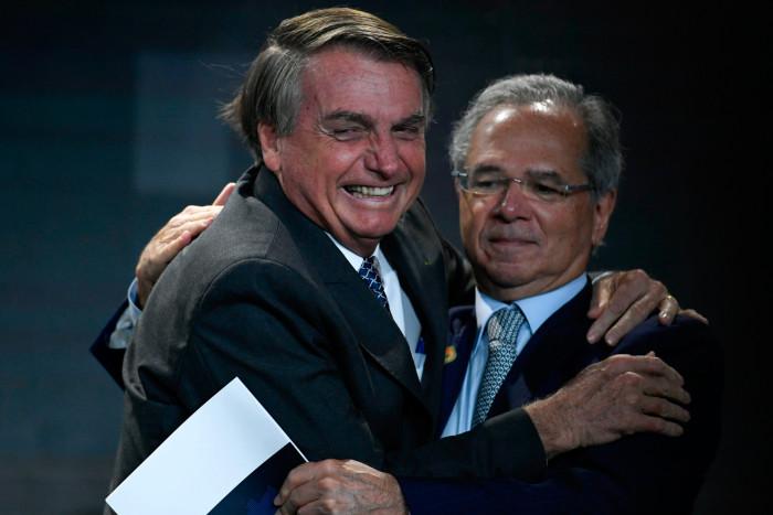 Jair Bolsonaro greets economy minister Paulo Guedes during a meeting with businessmen promoted by the National Confederation of Industry last December in Brasília