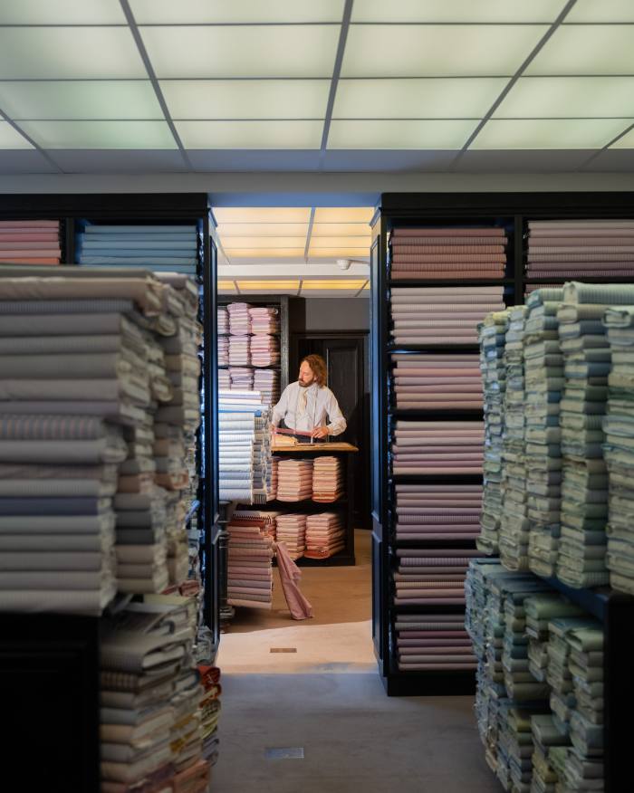 A tailor works on a bespoke shirt