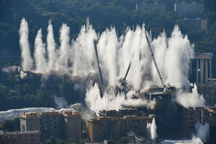 Explosive charges blow up the eastern pylons of Genoa’s Morandi motorway bridge