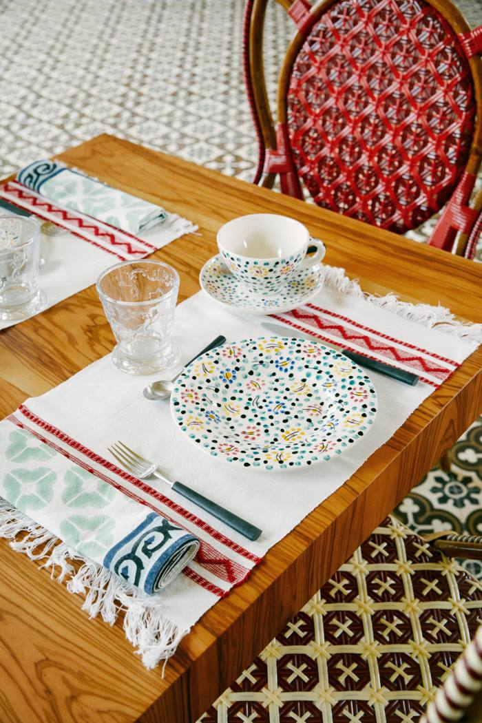 The breakfast table, set with Maison Gatti chairs and tableware by Portuguese label Vida Dura