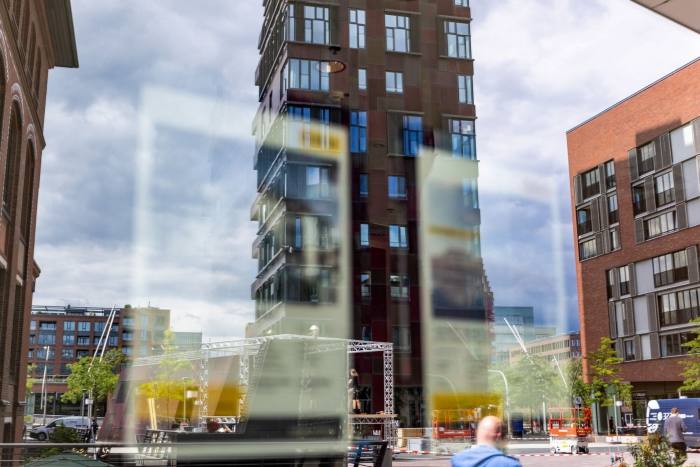 Un bloque de apartamentos reflejado en la ventana de un agente inmobiliario 