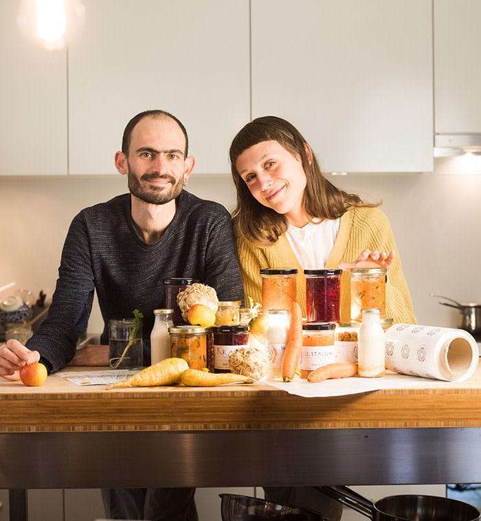 A couple sat at the table of their fermented foods business