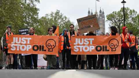 Just Stop Oil climate activists march in central London as part of their campaign calling on the UK government to end approval for exploring, developing and producing fossil fuels