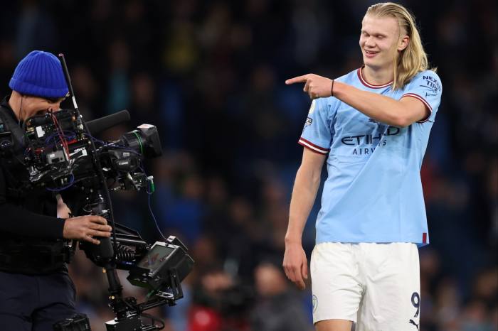 Manchester City's Erling Haaland points to TV cameras