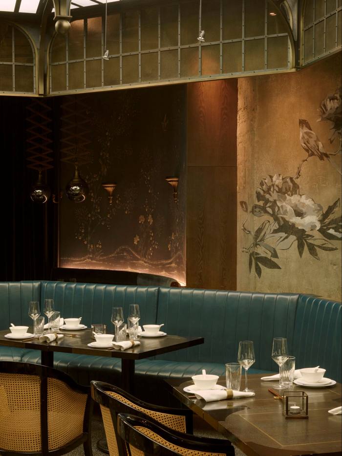     The interior of the Mott 32, with its green leather seats and its birds and flowers painted on the wall