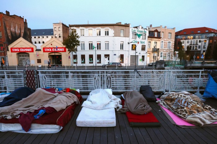 Asylum seekers sleep on a street in central Brussels, Belgium, in October