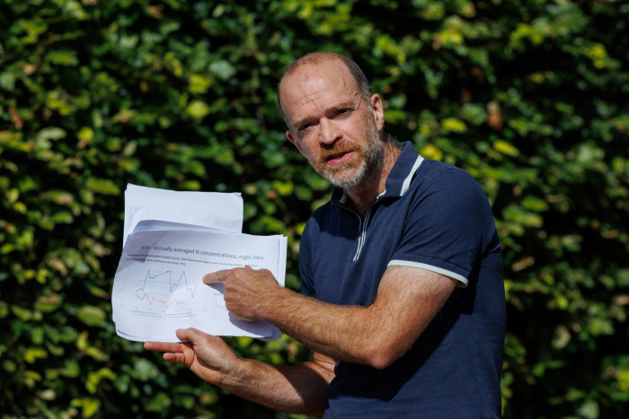 Dorset farmer Gerard Wynn holds up a printed graph showing nitrogen levels