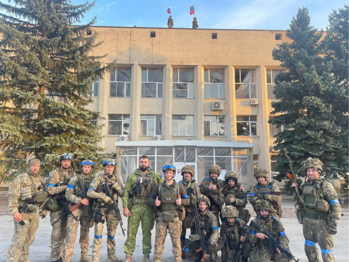 Ukrainian troops pose for a photo in Lyman