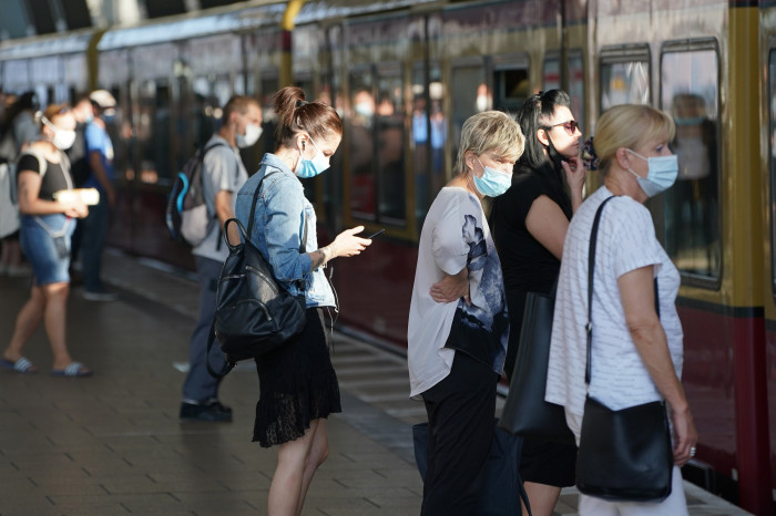 Commuters wearing protective masks
