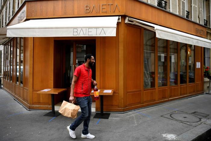A customer picks up his order at Baieta in Paris