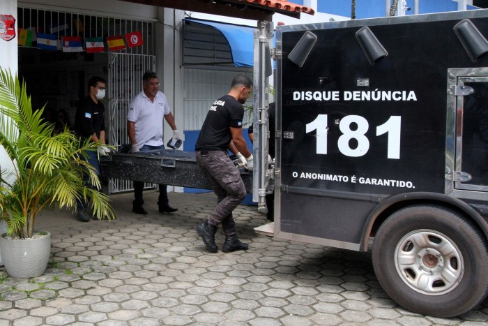 A shooting victim is carried from a school in Aracruz in the Brazilian state of Espirito Santo