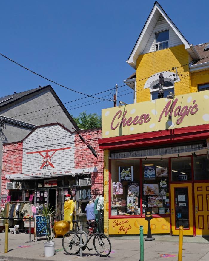 A Victorian house painted yellow and converted into a shop called Cheese Magic in Kensington Market