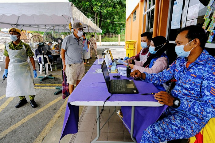 Malaysians register to receive a dose of the Sinovac vaccine in Port Klang