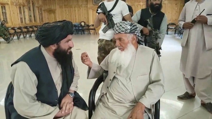 A screenshot from a video released by the Taliban on August 13 showing Ismail Khan talking to an unidentified Taliban official in Herat