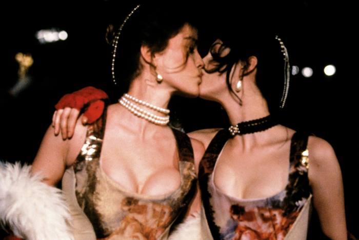Models kiss as they wear outfits during a fashion show by British designer Vivienne Westwood. (Photo by John van Hasselt/Sygma via Getty Images)