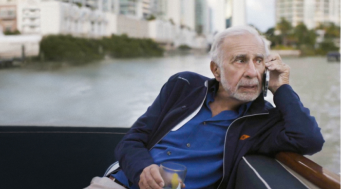 Carl Icahn talking on a phone while on a boat