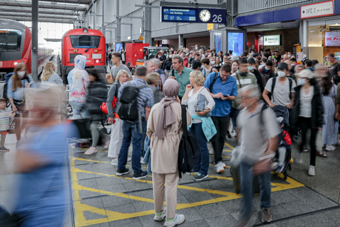 People arrive on a train platform at Hauptbahnhof railway station during the Pentecost long weekend on June 4 2022 in Munich, Germany