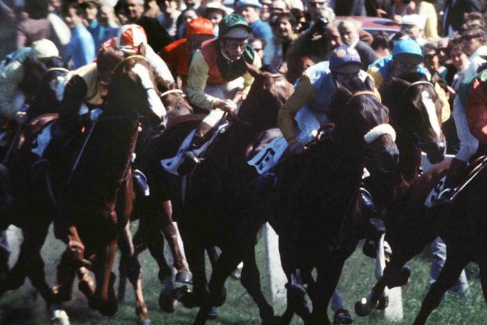 Piggott, centre, on Nijinsky as he and other riders race out of the starting stalls