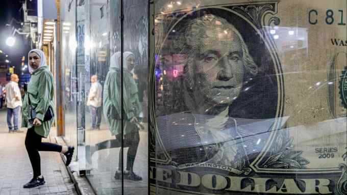 A woman walks out of a currency exchange shop displaying a giant US dollar banknote