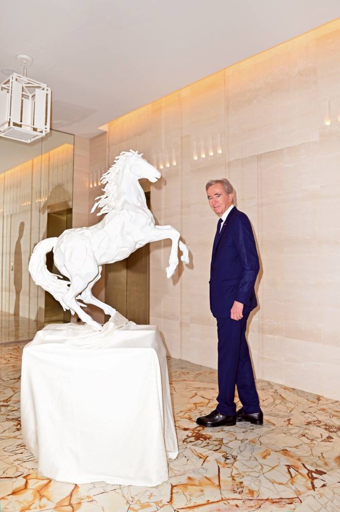 Bernard Arnault with the hotel’s own cheval blanc sculpture by Frank Gehry