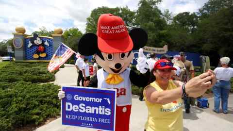 A person wearing a mouse costume takes selfies with supporters of Florida’s Republican-backed ‘Don’t Say Gay’ bill