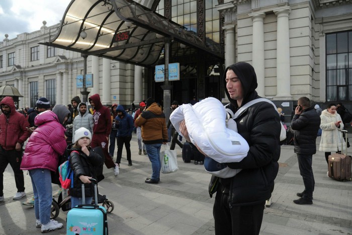 People fleeing the war at Lviv railway station on Saturday