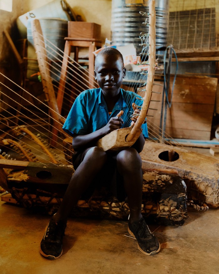 Playing an adungu (bow harp) in one of the new classrooms