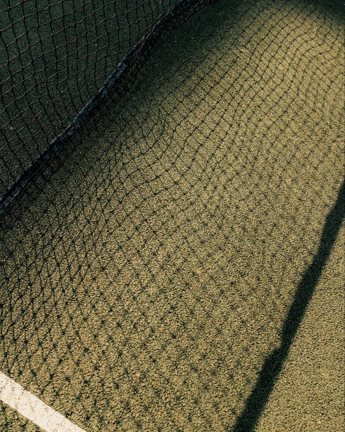The shadow of a tennis net upon a court at Golden Lane