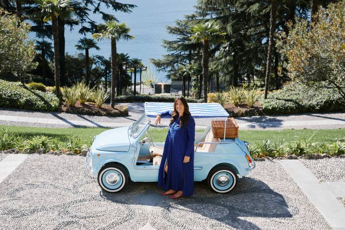Valentina De Santis next to the vintage electric Fiat 500 convertible that takes guests between the terraces of the villa