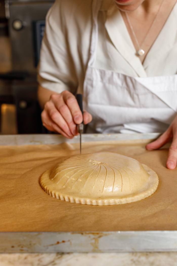 Scoring the pastry before baking