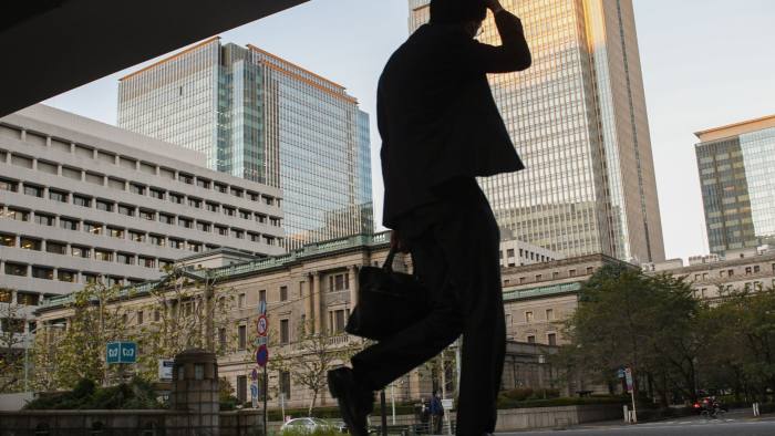 A pedestrian in front of the Bank of Japan in Tokyo
