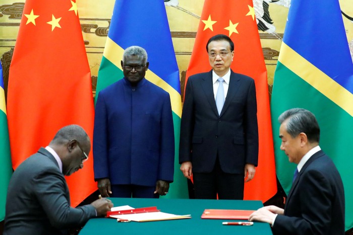 Jeremiah Manele, Solomon Islands foreign minister, Manasseh Sogavare, the prime minister, Chinese Premier Li Keqiang and Chinese state councillor and foreign minister Wang Yi attend a signing ceremony at the Great Hall of the People in Beijing in 2019