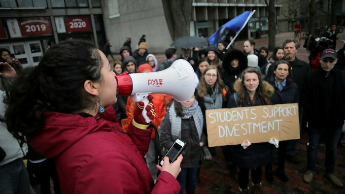 Protesters at a 2017 rally urge Boston University to divest from fossil fuels