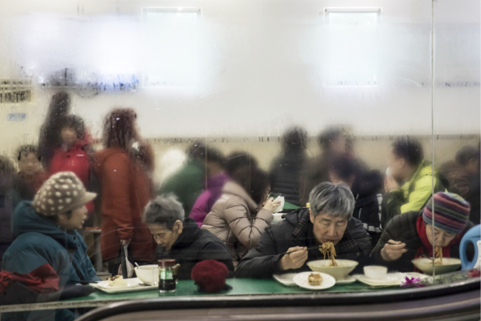 Customers eat noodles inside a restaurant in Beijing