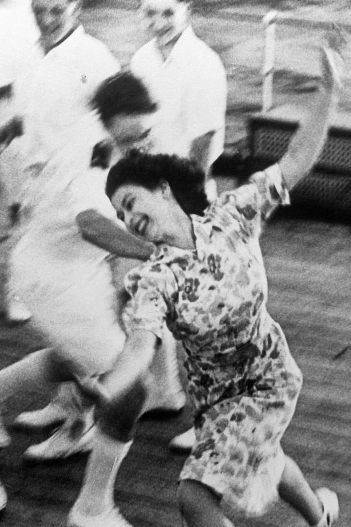The princess, laughing, plays tag with the midshipmen aboard HMS Vanguard that same year