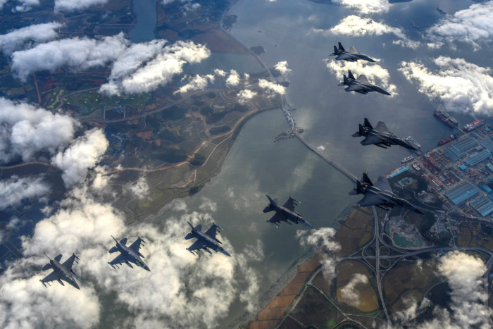 Four South Korean Air Force F-15Ks and four U.S. Air Force F-16 fighter jets fly over South Korea for drills in response to a North Korean missile test. 