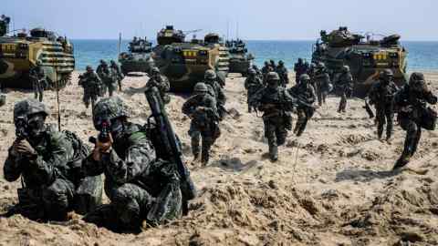 Troops land on a beach during a military exercise