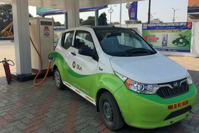 An electric vehicle operated by Indian ride-hailing company Ola at a charging station in Nagpur