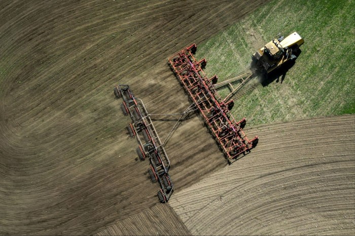 Aerial view of  tractor ploughing a field